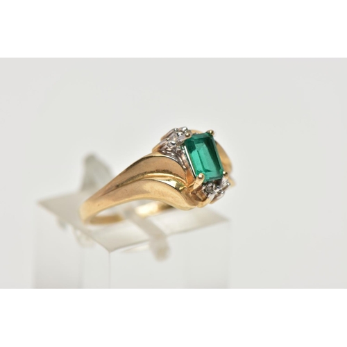 54 - A YELLOW METAL SYNTHETIC EMERALD AND DIAMOND RING, set with a rectangular cut synthetic emerald, wit... 