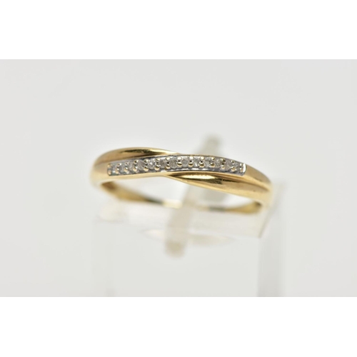 55 - A 9CT YELLOW GOLD DIAMOND CROSSOVER BAND RING, set with thirteen single cut diamonds, claw set to th... 