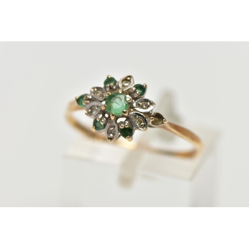 58 - A 9CT YELLOW GOLD EMERALD AND DIAMOND CLUSTER RING, set with a circular cut emerald, within an emera... 