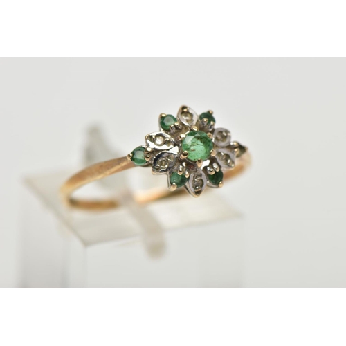 58 - A 9CT YELLOW GOLD EMERALD AND DIAMOND CLUSTER RING, set with a circular cut emerald, within an emera... 