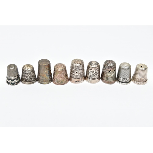 62 - AN ASSORTMENT OF SILVER AND WHITE METAL THIMBLES, five decorative silver thimbles, each hallmarked s... 