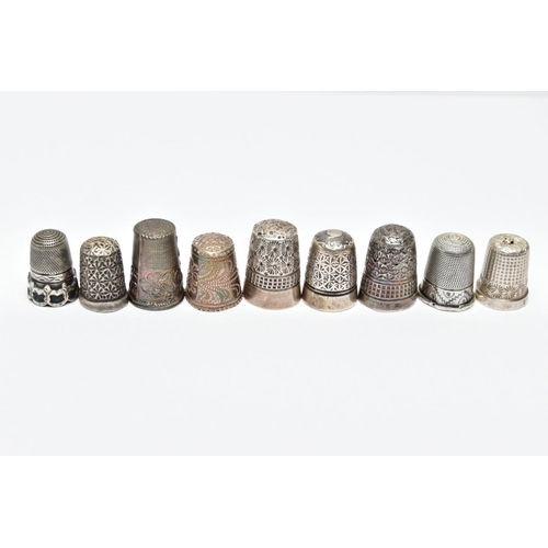 62 - AN ASSORTMENT OF SILVER AND WHITE METAL THIMBLES, five decorative silver thimbles, each hallmarked s... 