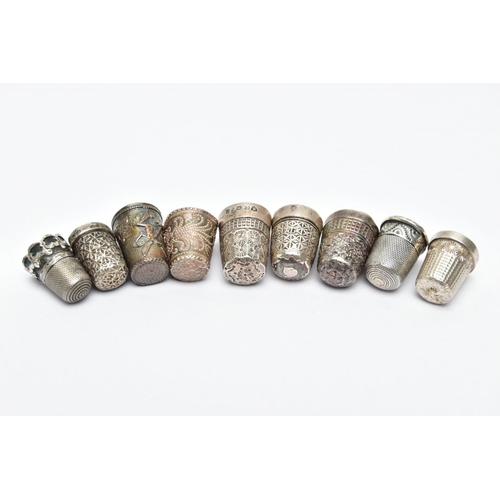 62 - AN ASSORTMENT OF SILVER AND WHITE METAL THIMBLES, five decorative silver thimbles, each hallmarked s... 