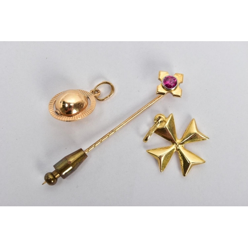 9 - TWO YELLOW METAL CHARMS AND A STICK PIN, to include a puffy Maltese cross charm fitted with an oval ... 