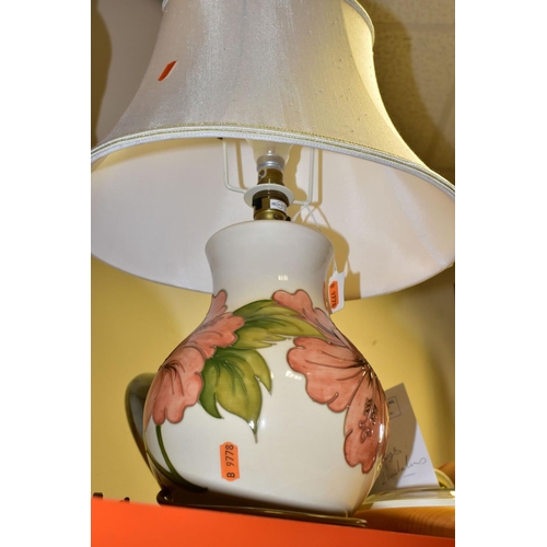 460 - A MOORCROFT POTTERY TABLE LAMP BASE DECORATED WITH A  CORAL 'HIBISCUS' DESIGN ON A CREAM BACKGROUND,... 