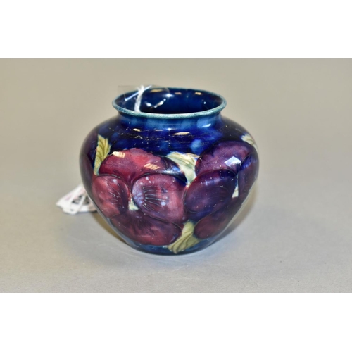 496 - A SMALL MOORCROFT POTTERY BALUSTER VASE, decorated with tube lined pink and purple Pansy pattern on ... 