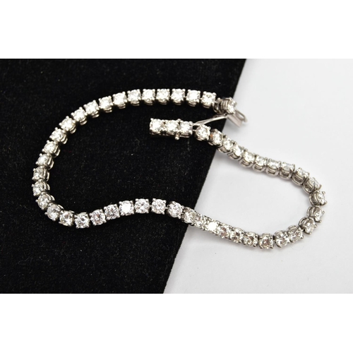 1 - A MODERN PLATINUM DIAMOND LINE BRACELET, set with fifty-two round brilliant cut diamonds, four claw ... 