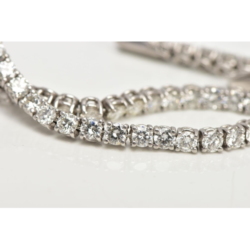 1 - A MODERN PLATINUM DIAMOND LINE BRACELET, set with fifty-two round brilliant cut diamonds, four claw ... 