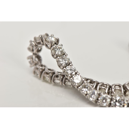 1 - A MODERN PLATINUM DIAMOND LINE BRACELET, set with fifty-two round brilliant cut diamonds, four claw ... 