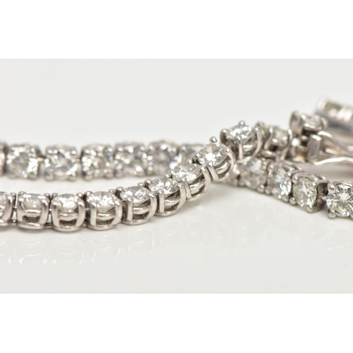 1 - A MODERN PLATINUM DIAMOND LINE BRACELET, set with fifty-two round brilliant cut diamonds, four claw ... 