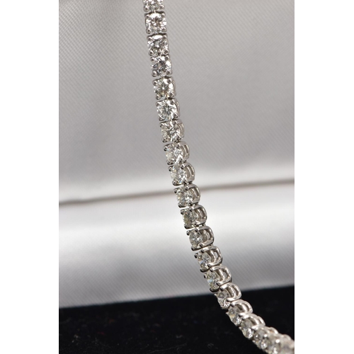 1 - A MODERN PLATINUM DIAMOND LINE BRACELET, set with fifty-two round brilliant cut diamonds, four claw ... 