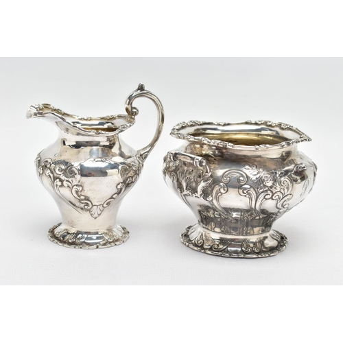 117 - AN EDWARDIAN SCOTTISH SILVER FOUR PIECE BACHELOR'S TEA SERVICE OF CIRCULAR, comprising tea pot, hot ... 