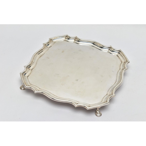 118 - A GEORGE V SILVER SALVER OF SHAPED SQUARE OUTLINE, pie crust edge, plain surface, four hoof feet, ma... 