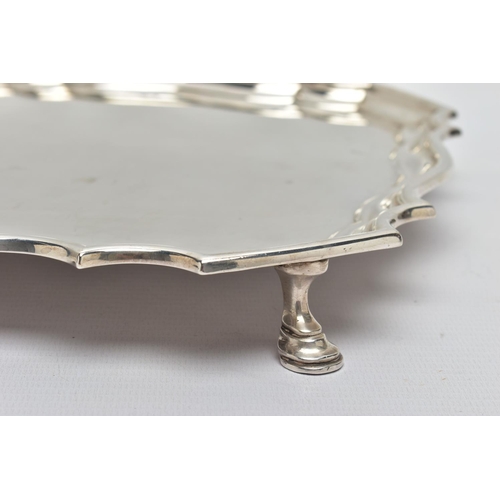 118 - A GEORGE V SILVER SALVER OF SHAPED SQUARE OUTLINE, pie crust edge, plain surface, four hoof feet, ma... 