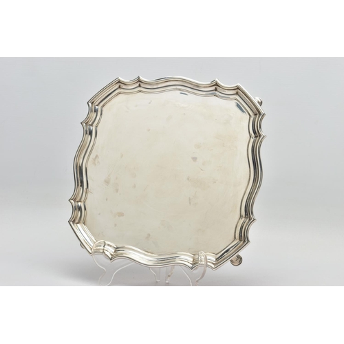 118 - A GEORGE V SILVER SALVER OF SHAPED SQUARE OUTLINE, pie crust edge, plain surface, four hoof feet, ma... 