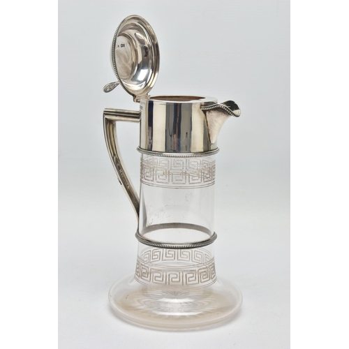 119 - A LATE VICTORIAN SILVER MOUNTED GLASS CLARET JUG, the hinged cover with foliate pierced thumbpiece, ... 