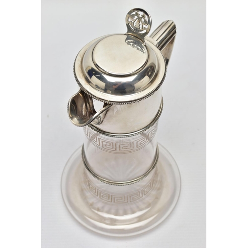 119 - A LATE VICTORIAN SILVER MOUNTED GLASS CLARET JUG, the hinged cover with foliate pierced thumbpiece, ... 