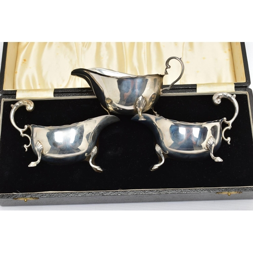 122 - A CASED PAIR OF GEORGE VI SILVER SAUCEBOATS, of oval form, S scroll handles, wavy rims, three cabrio... 