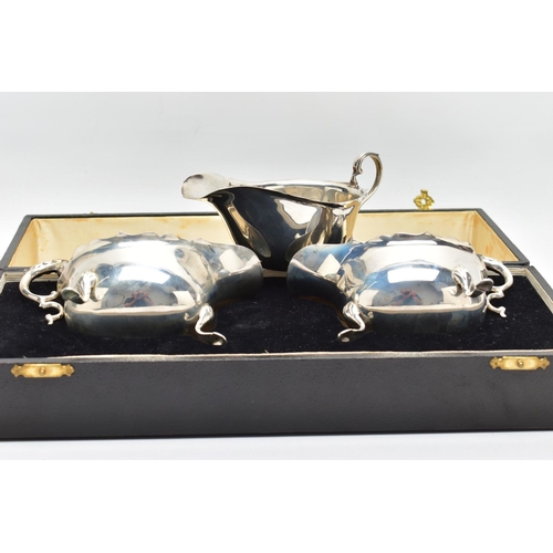 122 - A CASED PAIR OF GEORGE VI SILVER SAUCEBOATS, of oval form, S scroll handles, wavy rims, three cabrio... 