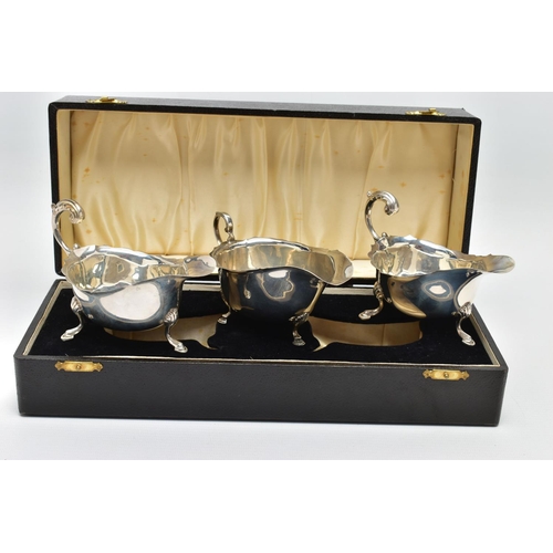 122 - A CASED PAIR OF GEORGE VI SILVER SAUCEBOATS, of oval form, S scroll handles, wavy rims, three cabrio... 