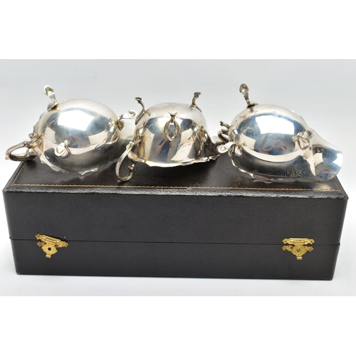 122 - A CASED PAIR OF GEORGE VI SILVER SAUCEBOATS, of oval form, S scroll handles, wavy rims, three cabrio... 