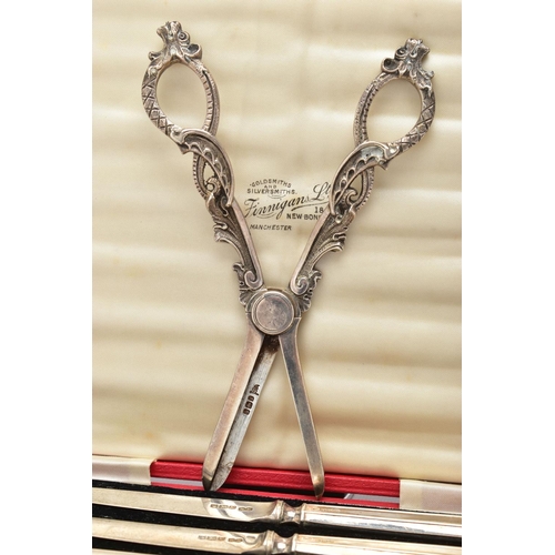 123 - A PAIR OF GEORGE V SILVER GRAPE SCISSORS, cast foliate scroll handles, makers Walker & Hall, Sheffie... 