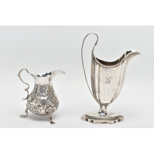 125 - TWO 18TH CENTURY SILVER CREAM JUGS, comprising a George III helmet shaped pedestal cream jug with re... 