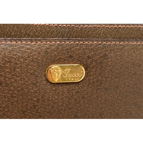 140 - A VINTAGE GUCCI BRIEFCASE WITH GREEN LEATHER TRIM, the front and back vinyl panels with Gucci logos ... 