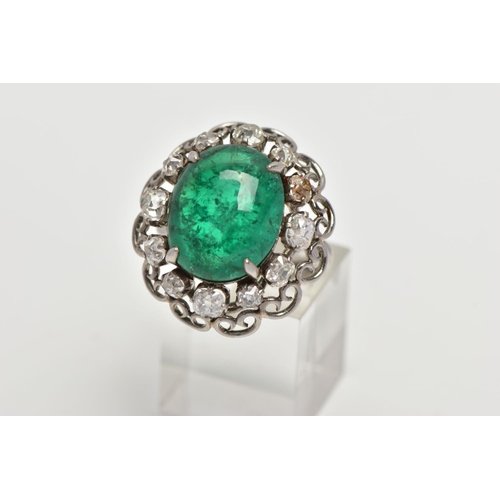 15 - AN EMERALD AND DIAMOND WHITE METAL CLUSTER RING, the principal oval cabochon emerald, measuring appr... 