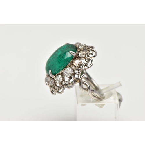 15 - AN EMERALD AND DIAMOND WHITE METAL CLUSTER RING, the principal oval cabochon emerald, measuring appr... 