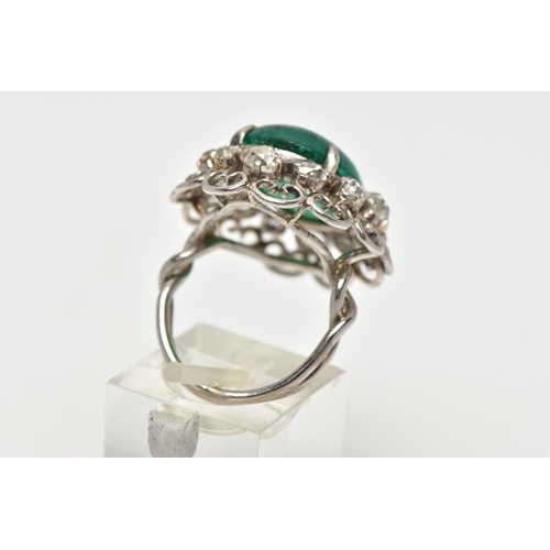 15 - AN EMERALD AND DIAMOND WHITE METAL CLUSTER RING, the principal oval cabochon emerald, measuring appr... 