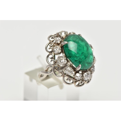 15 - AN EMERALD AND DIAMOND WHITE METAL CLUSTER RING, the principal oval cabochon emerald, measuring appr... 