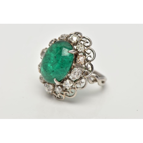 15 - AN EMERALD AND DIAMOND WHITE METAL CLUSTER RING, the principal oval cabochon emerald, measuring appr... 