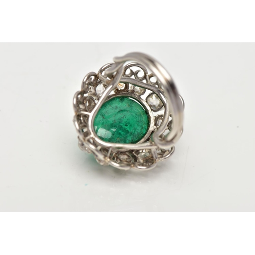 15 - AN EMERALD AND DIAMOND WHITE METAL CLUSTER RING, the principal oval cabochon emerald, measuring appr... 