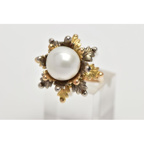 16 - A WHITE AND YELLOW METAL CULTURED PEARL RING, of foliate design, set with a principal part drilled w... 