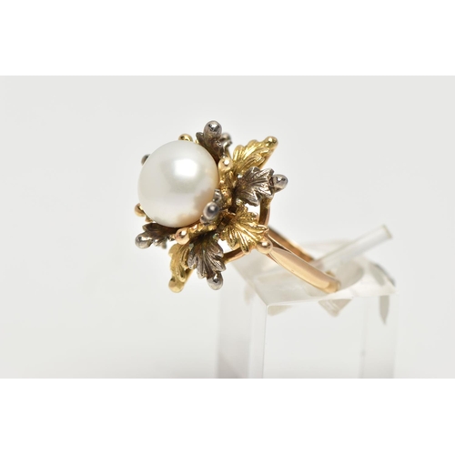 16 - A WHITE AND YELLOW METAL CULTURED PEARL RING, of foliate design, set with a principal part drilled w... 