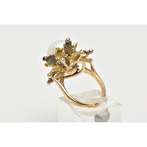 16 - A WHITE AND YELLOW METAL CULTURED PEARL RING, of foliate design, set with a principal part drilled w... 