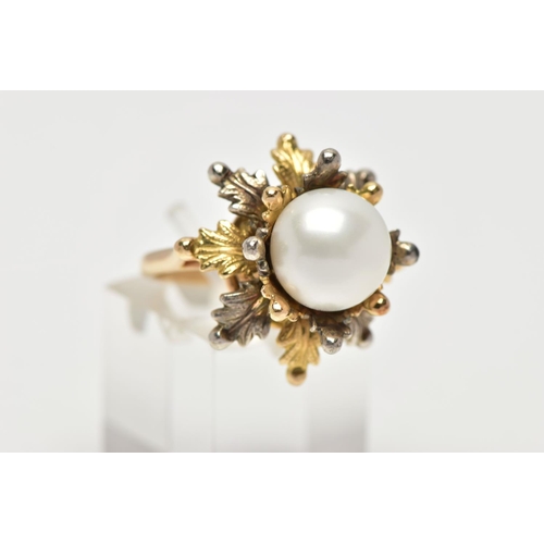 16 - A WHITE AND YELLOW METAL CULTURED PEARL RING, of foliate design, set with a principal part drilled w... 