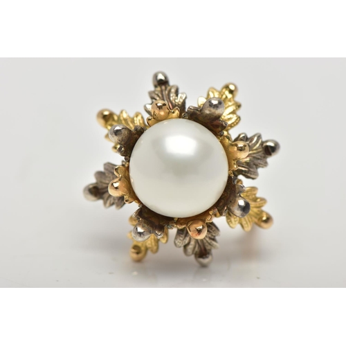 16 - A WHITE AND YELLOW METAL CULTURED PEARL RING, of foliate design, set with a principal part drilled w... 