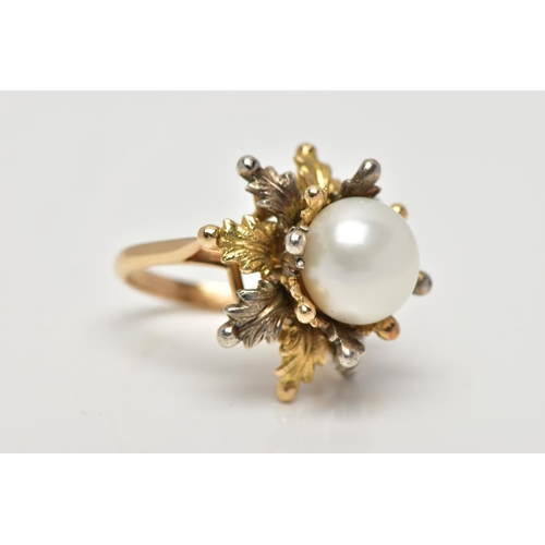 16 - A WHITE AND YELLOW METAL CULTURED PEARL RING, of foliate design, set with a principal part drilled w... 