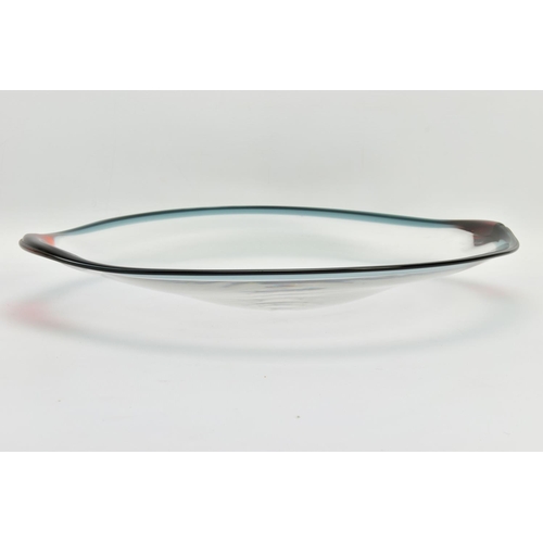 198 - NEIL WILKIN (BRITISH 20TH CENTURY) A LARGE SHALLOW GLASS BOWL, having a clear body and coloured rim,... 