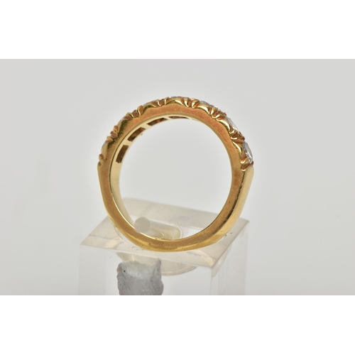 21 - A MODERN 18CT YELLOW GOLD DIAMOND SEVEN STONE RING, set with round brilliant cut diamonds, measuring... 