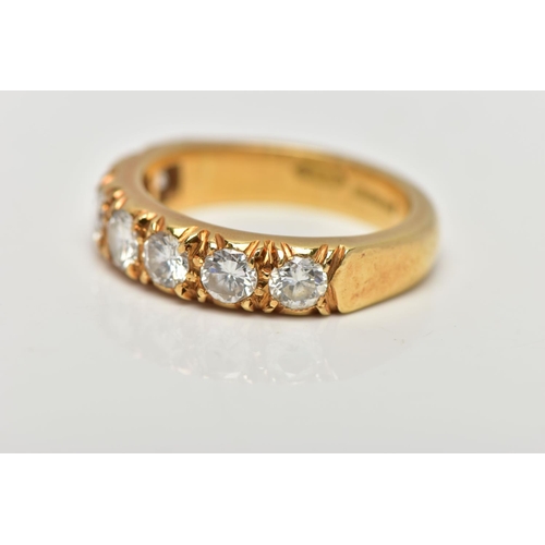 21 - A MODERN 18CT YELLOW GOLD DIAMOND SEVEN STONE RING, set with round brilliant cut diamonds, measuring... 