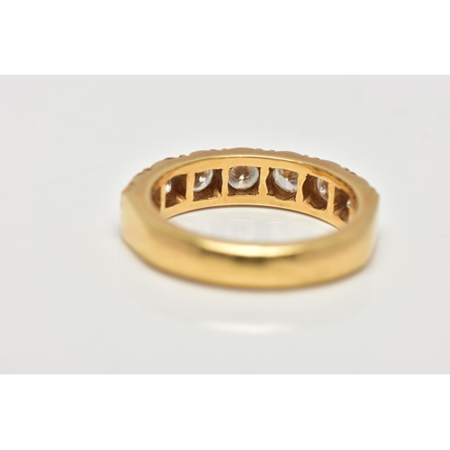 21 - A MODERN 18CT YELLOW GOLD DIAMOND SEVEN STONE RING, set with round brilliant cut diamonds, measuring... 