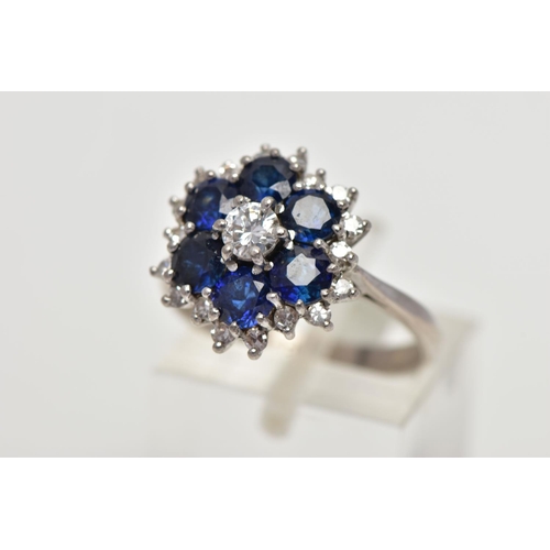 22 - A SAPPHIRE AND DIAMOND CLUSTER RING, set with a principal round brilliant-cut diamond, surrounded by... 