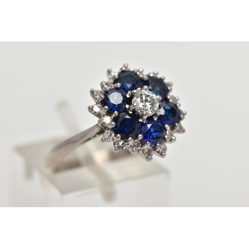 22 - A SAPPHIRE AND DIAMOND CLUSTER RING, set with a principal round brilliant-cut diamond, surrounded by... 