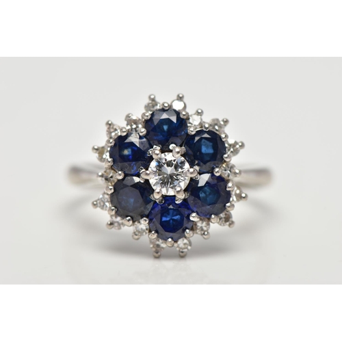 22 - A SAPPHIRE AND DIAMOND CLUSTER RING, set with a principal round brilliant-cut diamond, surrounded by... 