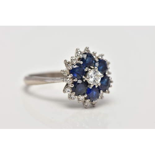 22 - A SAPPHIRE AND DIAMOND CLUSTER RING, set with a principal round brilliant-cut diamond, surrounded by... 