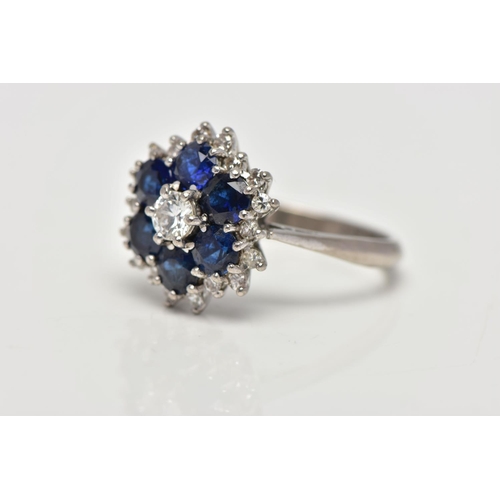 22 - A SAPPHIRE AND DIAMOND CLUSTER RING, set with a principal round brilliant-cut diamond, surrounded by... 