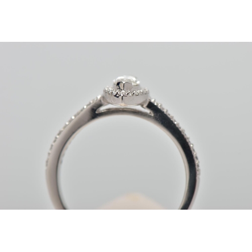 23 - A PLATINUM DIAMOND HALO RING, centring on a marquise cut diamond, estimated diamond weight 0.50cts, ... 